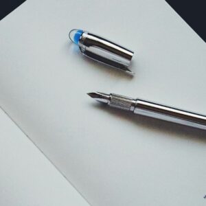 silver and blue click pen