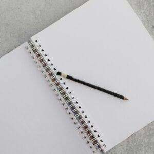 a notebook with a pencil on top of it