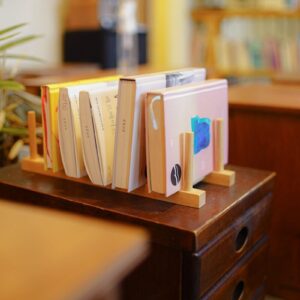 white books on brown wooden shelf