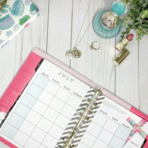 white and pink spiral notebook