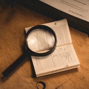 a magnifying glass sitting on top of an open book