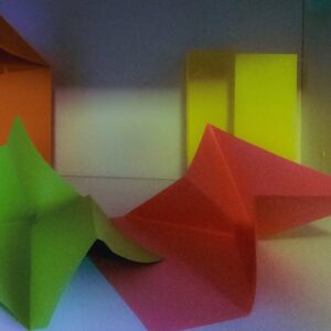Colorful origami shapes arranged in a still life.