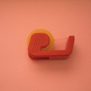 orange plastic tool on white table