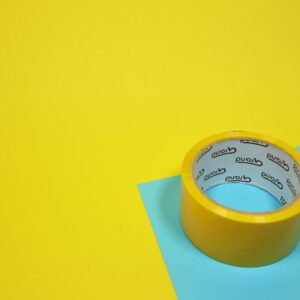 yellow duct tape on blue surface